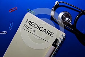 Medicare Part d write on book isolated on wooden table. Medical or Finance concept