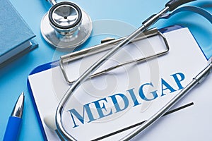 Medicare Supplement Insurance Medigap application and stethoscope. photo