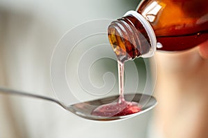 Medication or antipyretic syrup and spoon