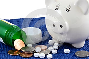 Medication Coins And Piggy Bank On Blue