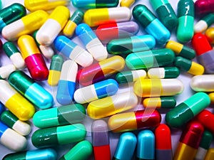 Medication and healthcare concept. Heap of colorful capsules med