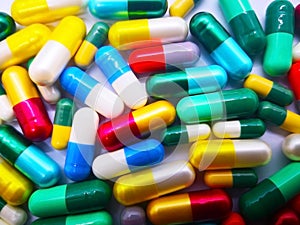Medication and healthcare concept. Heap of colorful capsules med