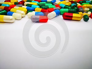 Medication and healthcare concept. Heap of colorful tablets medicine. Isolated on white background, selective focus and copy