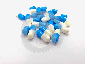 Medication and healthcare concept. Many blue-white capsules of D