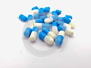 Medication and healthcare concept. Many blue-white capsules of D photo