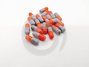 Medication and healthcare concept. Many gray-orange capsules of