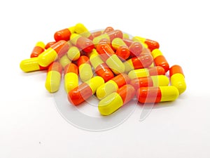 Medication and healthcare concept. Many orange-yellow capsules o