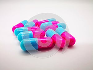 Medication and healthcare concept. Many pink-blue capsules of It