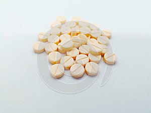 Medication and healthcare concept. Many round light orange pills