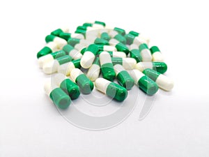 Medication and healthcare concept. Many white-green capsules of