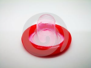 Medication and healthcare concept. Red condom, for birth control