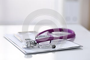 Medication history record form lying on table with stethoscope and silver pen. Medicine or pharmacy concept. Medical