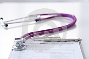 Medication history record form lying on table with stethoscope and silver pen. Medicine or pharmacy concept. Medical