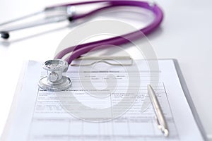 Medication history record form lying on table with stethoscope and silver pen. Medicine or pharmacy concept. Medical