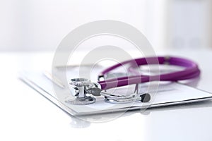 Medication history record form lying on table with stethoscope and silver pen. Medicine or pharmacy concept. Medical