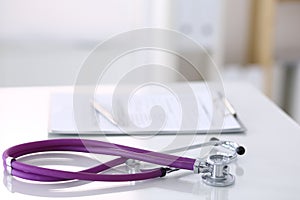 Medication history record form lying on table with stethoscope and silver pen. Medicine or pharmacy concept. Medical