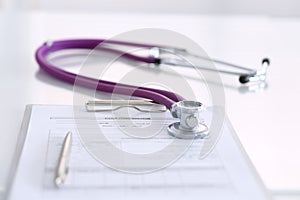 Medication history record form lying on table with stethoscope and silver pen. Medicine or pharmacy concept. Medical