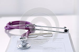 Medication history record form lying on table with stethoscope and silver pen. Medicine or pharmacy concept. Medical