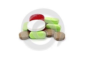 Medication pills are a bunch of multi-colored objects isolated on a white.