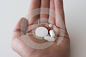 medication pills in hand. drugs, antibiotics, analgesics, narcotic photo