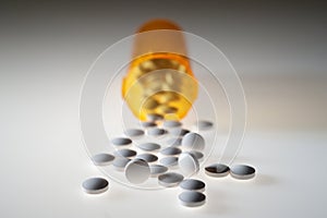 Medication pills pouring out of bottle