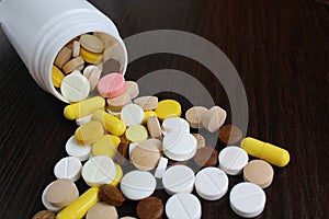 Medication tablets are capsized on the table