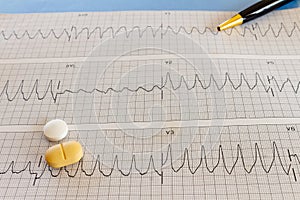 Medications with drugs for medical treatments. Medicines for legal use in humans. Drugs on EKG paper