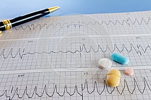 Medications with drugs for medical treatments. Medicines for legal use in humans. Drugs on EKG paper