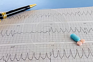 Medications with drugs for medical treatments. Medicines for legal use in humans. Drugs on EKG paper