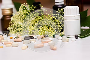 Medications, tablets and pill bottles with green herb