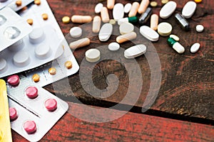 Medications and tablets on a wooden texture table