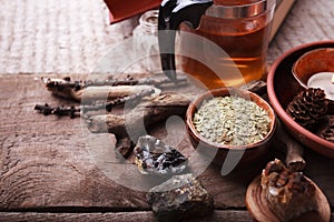 Medicinal herbs, homeopathy, dried flowers, stones and glass teapot - alternative medicine, relax concept, wooden background, copy