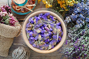 Medicinal herbs, mortar and bag of dry healthy flowers.