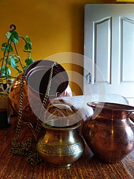 medicinal oils and Equipment, metal mugs used for Traditional Ayurveda therapies.