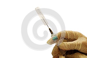 Medicine from an ampoule is drawn into a syringe.