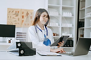 Medicine Asian doctor hand working with modern digital tablet computer interface as medical network concept