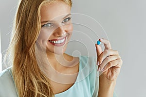 Medicine. Beautiful Smiling Woman Taking Medication Pill