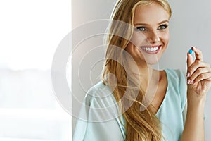 Medicine. Beautiful Smiling Woman Taking Medication Pill