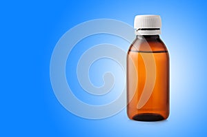 Medicine bottle of brown plastic on blue background