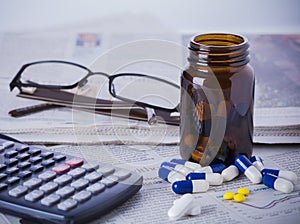 Medicine bottle, pills and financial data