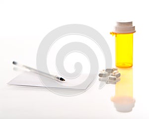 Medicine bottle, pills, prescription and pen