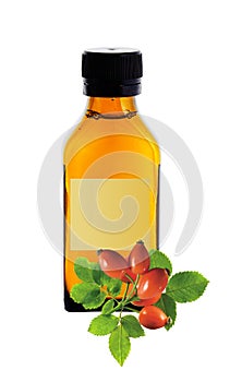 Medicine bottle with yellow syrup and dog-rose isolated on white