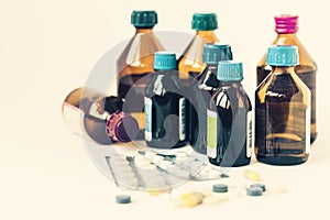 Medicine bottles, pills or capsules blister pack on white background with copy space for text, retro concept closeup