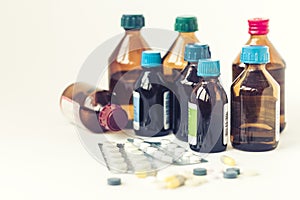 Medicine bottles, pills or capsules blister pack on white background with copy space for text, retro concept closeup