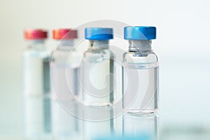 Medicine in bottles with red and blue capsule. On blue background. Copy space