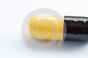 medicine capsule black and yellow on white background