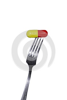 Medicine capsule on a fork