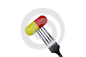 Medicine capsule on a fork