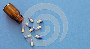 Medicine capsules on blue background. Health pharmacy concept