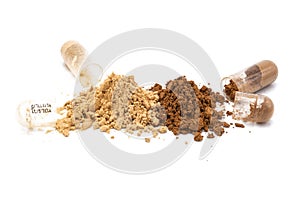 Medicine capsules and the powder that has been poured out on white background